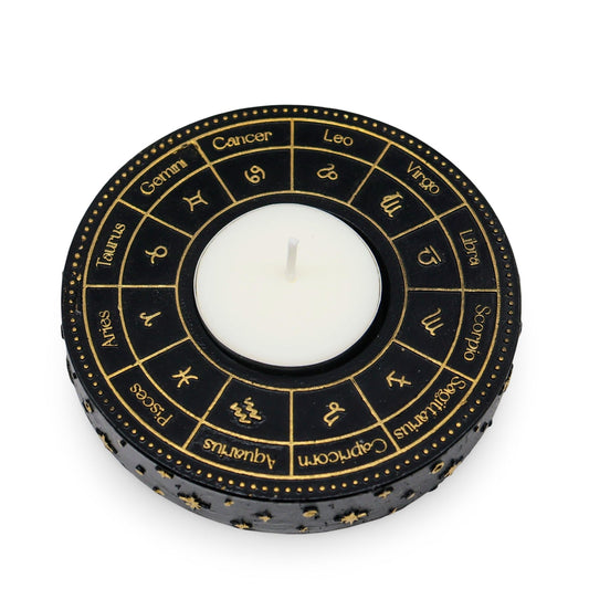 Astrology Wheel Zodiac tealight candle holder with intricate gold-effect design featuring zodiac signs and a white candle in the center.
