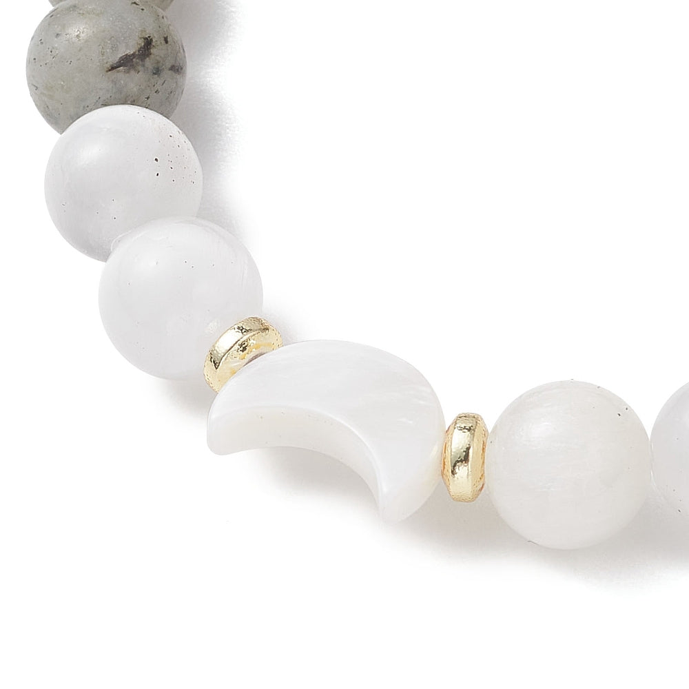 Close-up of a bracelet with white beads and gold accents on a white background